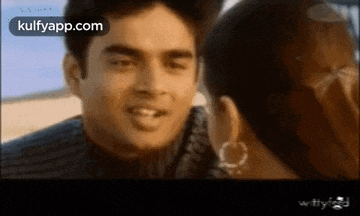a man and a woman are looking at each other in a movie .