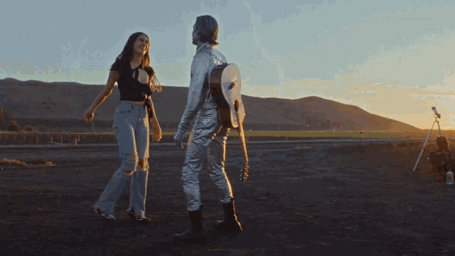 a man and a woman are dancing in a field