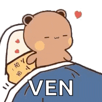 a cartoon teddy bear is laying in a bed with a pillow and a heart on it .