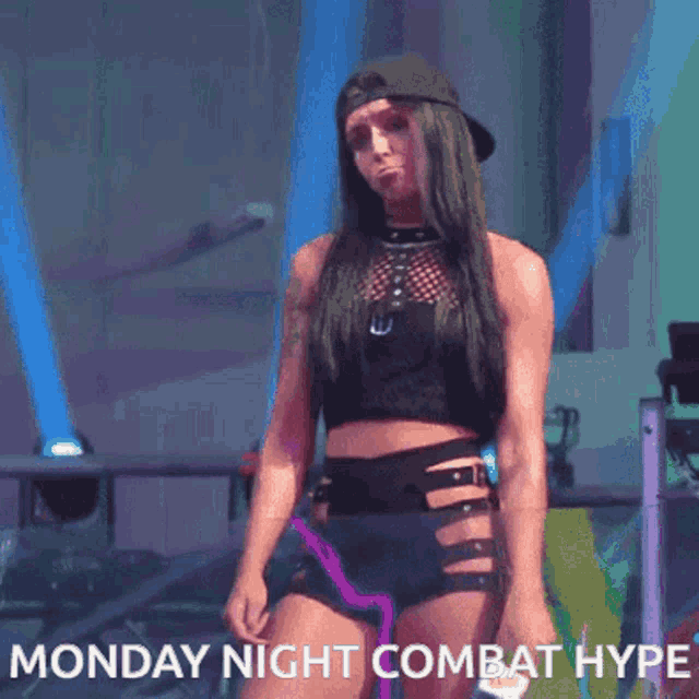 a woman in a crop top and shorts with the words monday night combat hype
