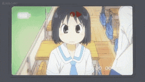 a girl in a school uniform is sitting at a desk in a classroom
