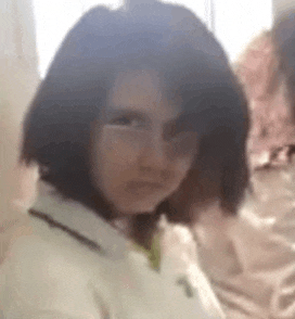 a close up of a person 's face with glasses and short hair .
