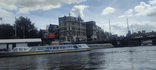 a boat that says ' amsterdam ' on the side is floating on a body of water
