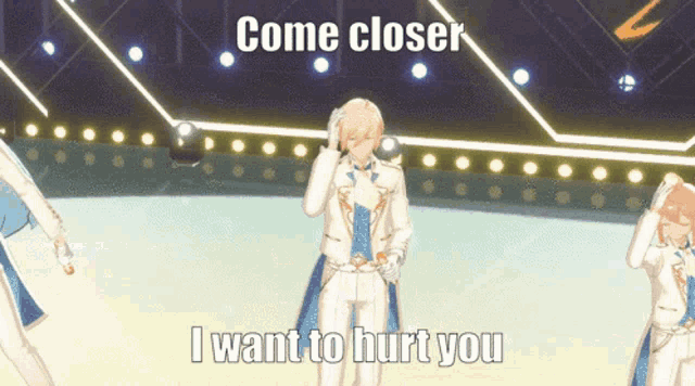 a man in a white suit stands on a stage with the words come closer i want to hurt you above him