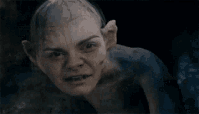 a close up of a person 's face with a bald head and ears