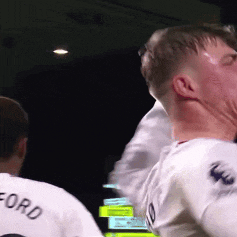 a man wearing a white shirt with the word ford on the back