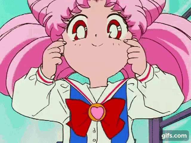 a girl with pink hair is wearing a sailor suit with a bow and a heart on it .