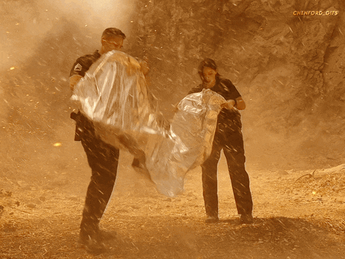 a man and a woman are standing in a field with chenford gifs written in the corner