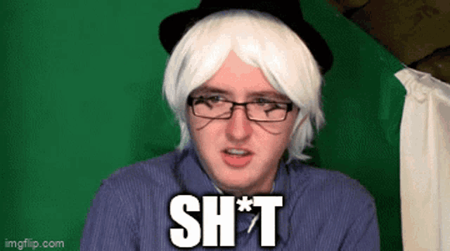 a man wearing glasses and a hat says shit