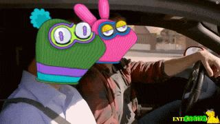 a man is driving a car with a cartoon character on his head and the words enterprise on the bottom