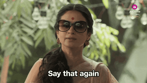a woman wearing sunglasses and a red dot on her forehead says say that again