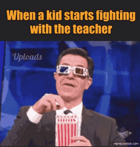 a man wearing 3d glasses is holding a box of popcorn