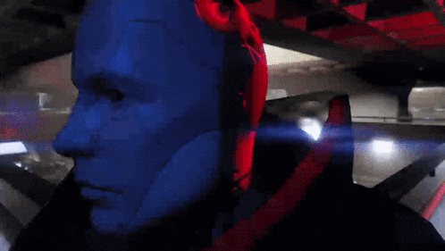 a close up of a robot 's face with blue eyes