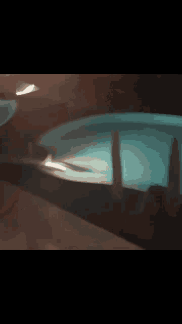 a person is standing in a pool at night