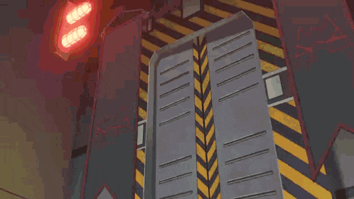 a yellow light is coming out of a metal door in a building .