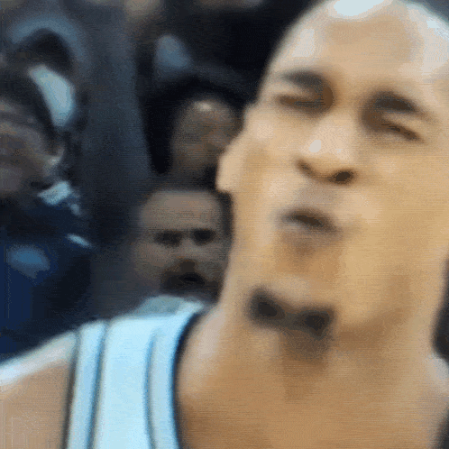 a close up of a man 's face with a bow on his neck