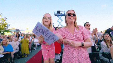 a little girl holding a sign that says ' loreen '