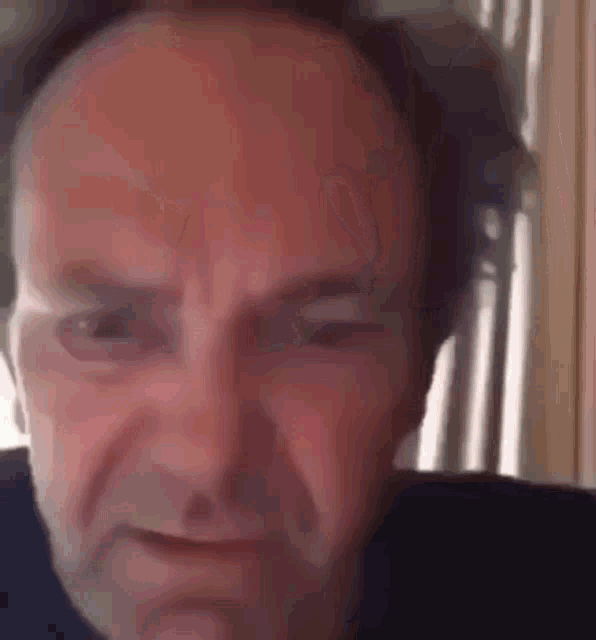 a man wearing headphones is making a funny face .