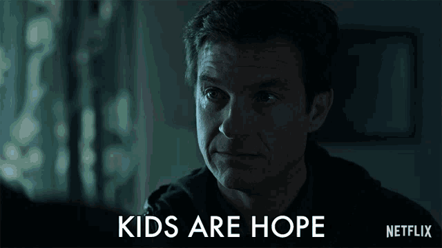 a man in a dark room with the words kids are hope