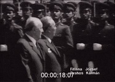 a black and white photo of men in suits and hats with the time of 00 : 00 : 18 : 07