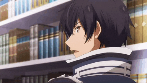 a man is standing in front of a bookshelf in a library looking at something .