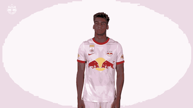 a soccer player wearing a white shirt with red bulls on it