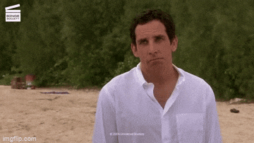 a man in a white shirt is standing on a sandy beach with a watermark that says universal studios