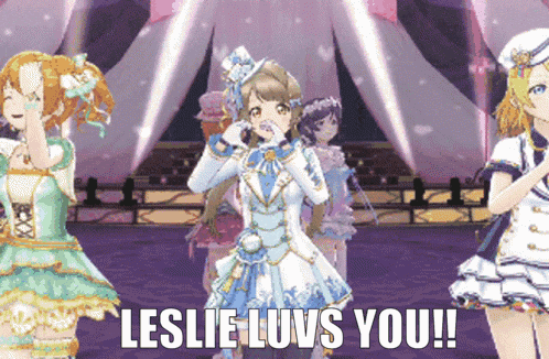 a group of anime girls standing on a stage with the words " leslie luvs you "