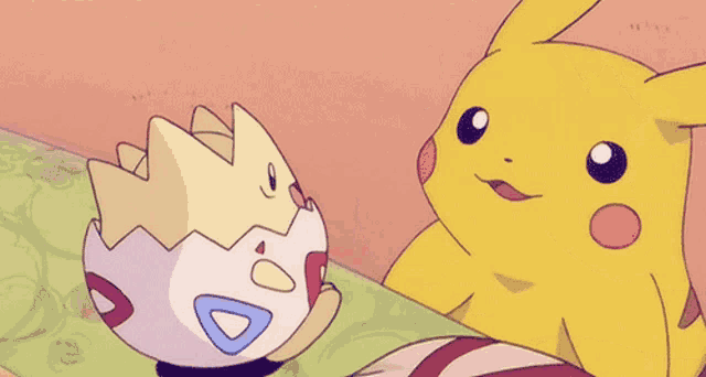 a pikachu and a togey are playing with each other