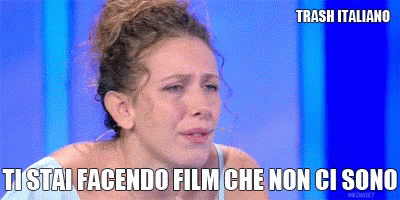 a woman is crying in front of a blue background that says trash italiano on it
