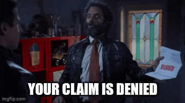 a man with a beard is holding a piece of paper that says your claim is denied
