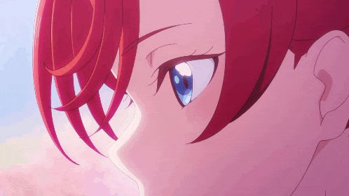 a close up of a person 's eyes with red hair