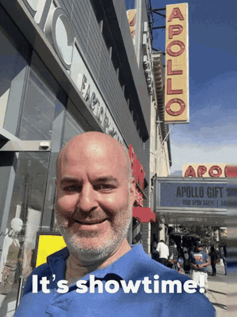 a man standing in front of an apollo theater
