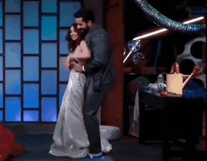a man and woman are dancing on a stage .