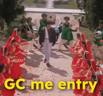 a man standing in front of a group of people with the words gc me entry written below him