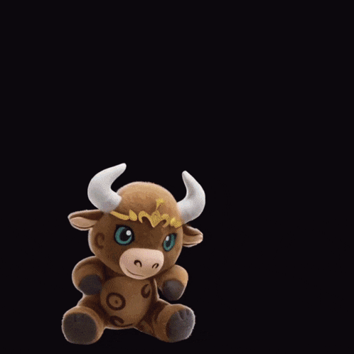 a stuffed bull with horns and a crown is standing in front of a purple letter u