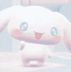 a close up of a cinnamoroll stuffed animal standing on a floor .