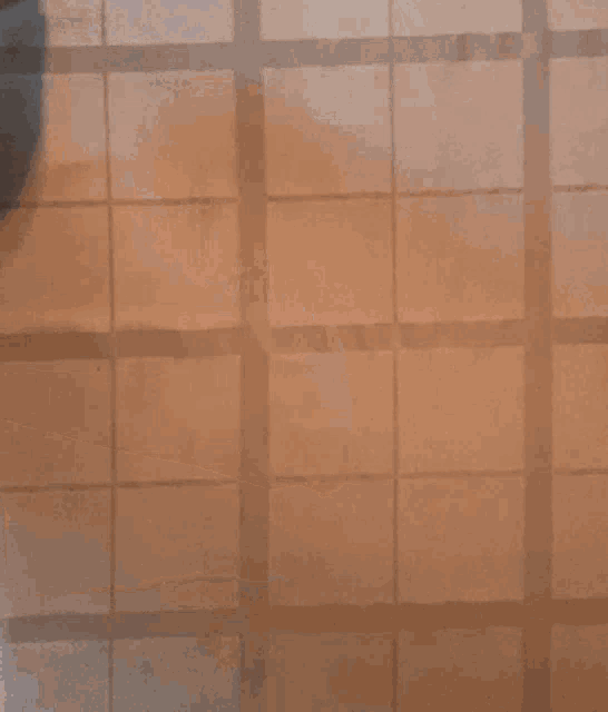 a person is stirring a pot of food on a checkered tablecloth