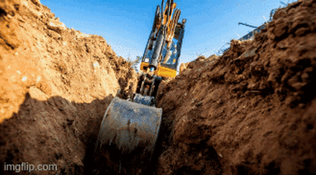 an excavator is digging a hole in the dirt