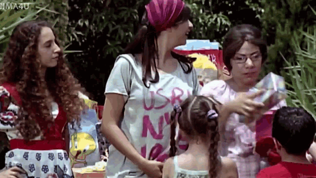 a woman wearing a usr ny shirt is standing next to a girl