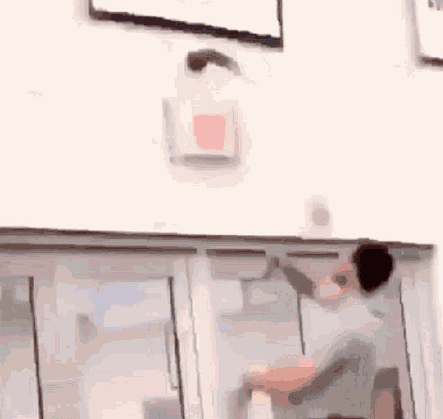 a blurry picture of a man cleaning a window .