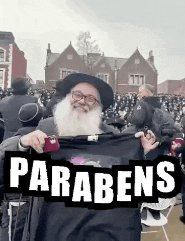 a man with a beard is holding a black t-shirt with the word parabens on it .