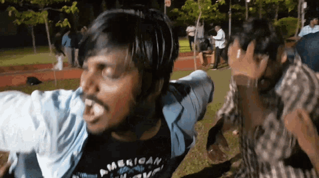 a man wearing a black shirt that says american is screaming