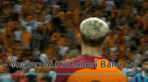 a soccer player stands in front of a crowd with the words yanlari al hamsileri bana sal written on the bottom