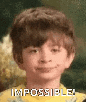 a young boy is smiling and making a face with the words `` impossible '' behind him .