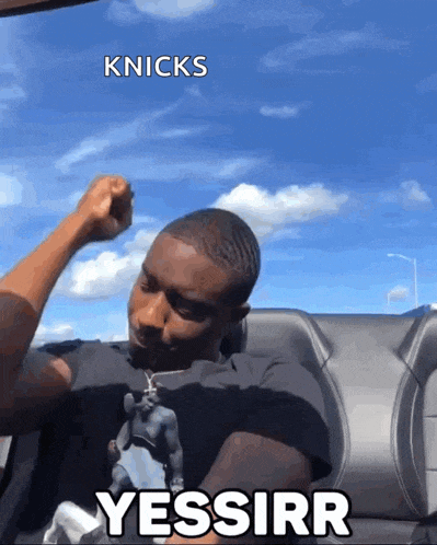 a man on a boat with the words knicks yessirr written on the bottom