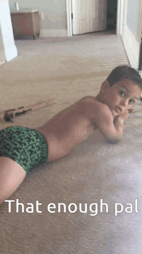 a young boy laying on the floor with the words that enough pat