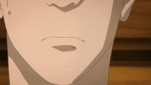 a close up of a person 's face with a slight smile