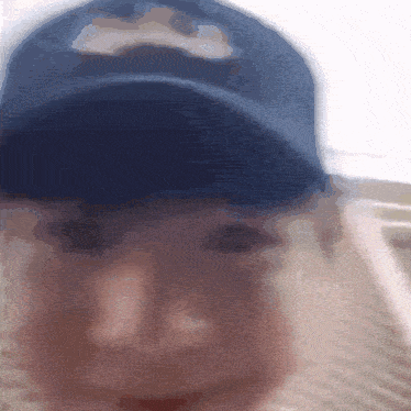 a blurry picture of a man wearing a blue hat