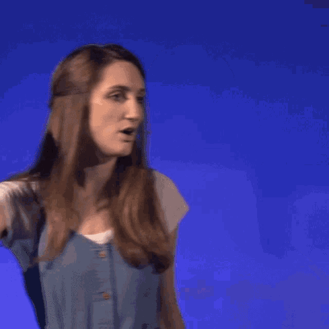 a woman with a microphone in her mouth is making a face